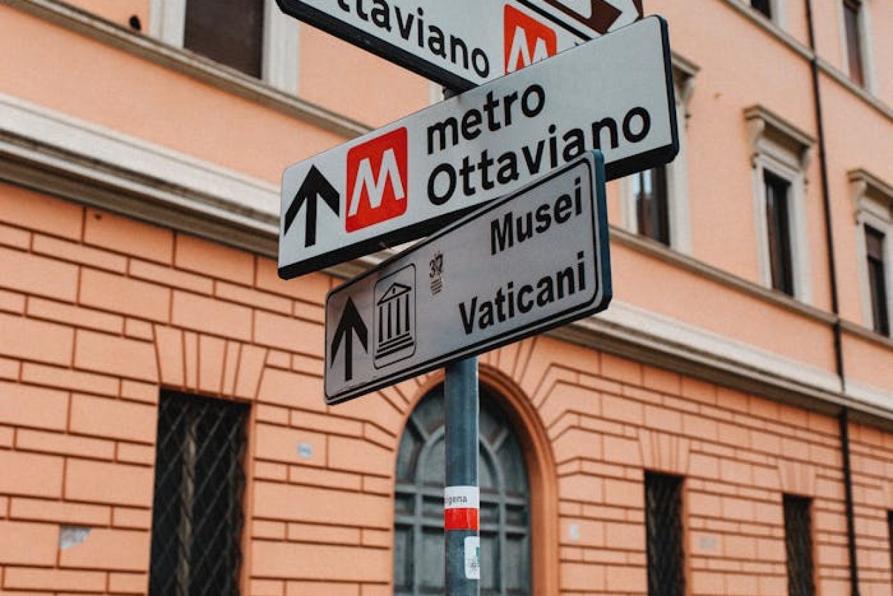 Street signs near Museo Storico Arma dei Carabinieri guiding to Ottaviano Metro and Vatican in Rome.